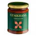 Six glass bottles of Gymkhana Vindaloo Cooking Sauce stand in a neat row. Each 300ml bottle shows vibrant orange-red sauce through clear glass; a black-and-gold label displays the Gymkhana logo, spice illustrations and bold typography. Metal caps catch studio light. Reflections and soft shadows outline
