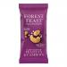 A small impulse-size Forest Feast packet sits on a rustic wooden surface. The colorful wrapper shows slow-roasted peanuts and cashews imagery. Shelled peanuts, cashews, sunflower seeds and dried fruit spill around the pack, creating a casual, natural arrangement. Soft highlights emphasize nutty sheen.