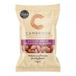 Compact Cambrook packet of Hickory Smoke seasoned almonds shows a matte pouch with amber and brown hues. The front features a close photo of lightly smoked almonds spilling from a bowl next to bold brand lettering and a small 'Fruit, Nuts & Seeds' strip, with wisps of smoke artwork. Soft foil trim!!
