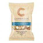 An open carton displays twenty-four 45g orange snack bags, each fronted by the Cambrook logo and a vivid photograph of mixed nuts — almonds, cashews and peanuts. Several packets lie stacked and scattered, showing front labels, ingredient text and the glossy snack-bag texture. Soft light gives sheen.