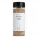 A clear plastic pouch displays pale, roasted sesame seeds. A minimalist cream-and-gray label across the front features the brand name in clean type and the product title in smaller text. The bag has a resealable top and a nutrition panel printed on the back.