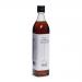 A clear 500ml bottle of toasted sesame oil stands upright, revealing warm amber-brown oil. The simple white label shows the Emma Basic brand and toasted sesame illustration with small print and barcode. A black screw cap tops the bottle, giving a neat grocery-store look. On a plain white background.