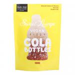 A bright pouch displays several cola-bottle gummies through a clear window; each bottle is brown with a sugar-dusted, fizzy surface. The bag features playful lettering, cola graphics and vegan labeling, set against a vibrant background with contrasting accent colors.