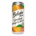 A neat row of twelve 330ml Belvoir Fruit Farm bottles sits on a pale wooden tabletop. Labels feature painted mango and peach artwork in warm orange and blush pink. Clear glass reveals a pale golden cordial, and silver bottle caps catch soft studio light, creating gentle highlights. Soft light glows.