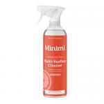 The image shows six identical 750ml Miniml Multi-Surface Cleaner bottles arranged in two rows. Clear bottles reveal vibrant blood-orange liquid; minimalist white labels display the brand name and a sliced orange illustration. Soft studio lighting casts subtle shadows.