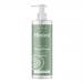 Six 500ml Miniml hand soap bottles sit in soft natural light. Clear pump bottles reveal pale green liquid. White minimalist labels display black 'Miniml' lettering alongside simple cucumber slices and aloe leaf illustrations. Evenly spaced on a clean surface, they cast gentle shadows. with soft sheen
