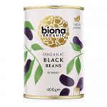 Photo shows six upright Biona Organic bags of black beans, each marked 400g. The packs have white and green branding, large 'Black Beans' text and organic logo. A small clear window reveals shiny black beans; bags stand against a plain light background.