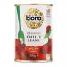 A single metal can of Biona Organic Chilli Beans fills the frame, its bright red label featuring the Biona logo, stylized chili and kidney bean imagery and white text. The metal rim and pull-tab gleam, while photograph lighting highlights label texture and canned contents illustration in vivid color.