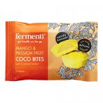 A compact box of 15 individually wrapped coco bites sits open, revealing neat rows of 9g mango & passion fruit morsels. Bright yellow and orange artwork shows sliced mango and passionfruit, while a single unwrapped bite exposes a glossy coconut fondant center and shredded coconut coating. dry crumbs
