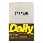 Six 200g Caravan Coffee Roasters Daily Ground bags stand in a neat row. Each matte pack displays the Caravan Coffee Roasters logo, the Daily Ground name and simple label graphics in muted colors, with sealed tops and soft grocery-shelf lighting.