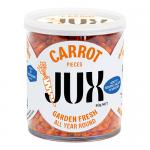 Six compact clear pouches stand in a neat row, each revealing uniformly diced bright-orange carrot pieces. Green-and-white JUX Food labels sit atop the packs, showing small text and a simple logo. The plastic reflects studio lighting against a neutral white background. Light glints off carrot edges.