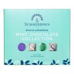A rectangular green and brown box shows the Summerdown logo in white script with gold trim. Photorealistic images of round dark chocolate discs broken to reveal pale mint filling sit beside fresh mint leaves. Subtle foil accents and nutritional text line the edges. Soft shadows add depth to the box.