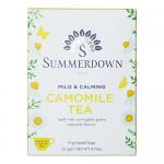 A small rectangular box sits on a neutral background. Soft yellow panels carry scattered chamomile illustrations and green leaves. A red emblem appears near the top, while bold serif text displays the brand and product name. Clean, simple packaging and a soothing color palette. Matte finish. Subtle.