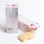 Dozen heart-shaped almond shortbreads sit neatly on parchment, their golden-brown edges contrasting pale buttery centers. Each cookie bears scattered flaked almonds and a light sugar dusting, revealing a crumbly texture and crisp, delicate finish. Soft light highlights slight oven-browned edges now.