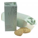 Golden heart-shaped shortbreads sit stacked on a rustic board, their tops are flecked with chopped rosemary and glinting sea-salt crystals. Slight surface cracks and crisp, browned edges reveal a tender, crumbly texture, light crumbs are scattered around the base.