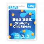 Six Brave Roasted Chickpeas Sea Salt sharing bags sit clustered on a neutral surface. Each matte pouch shows the Brave logo, product name and a clear window revealing golden-brown chickpeas. A small heap of roasted chickpeas and scattered sea-salt flakes lie in front. Soft shadows fall across scene.