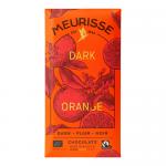 A Meurisse dark chocolate bar with orange rests on a pale surface. Its glossy, deep-brown segments show precise breaks and a dusting of bright orange zest. The wrapper lies beside it, white with elegant Meurisse lettering and orange graphic accents, neat and understated. Soft light frames the bars.