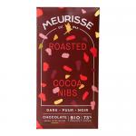 A rectangular dark-brown wrapper displays the Meurisse logo in metallic gold. A glossy dark chocolate bar with visible cocoa nibs sits beside it; nibs dot the surface and are scattered around. Minimal white text notes 100g on the clean, elegant packaging. Foil crinkles and cocoa-bean sketch details.