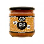A round tin displays the Bold Bean Classic Baked Beans label with bold navy and orange colors. The 325g weight appears near the brand name. A glossy photograph of baked beans fills a circular window while ingredient and nutritional text line the bottom and sides. Glossy lid and slightly crimped rim.