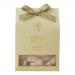 A rectangular box of roasted almond honey nougat features warm cream and gold packaging with a photo of glossy almond-studded nougat pieces. Elegant script and subtle floral accents frame the image.