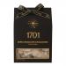 A sleek dark brown box features glossy images of rectangular nougat pieces enrobed in dark chocolate, scattered macadamia halves and a honey drizzle. Warm gold lettering and minimalist graphics frame the confection photos against a matte background. Subtle embossing and ribbon band add warm texture.