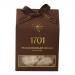 A rectangular box sits on a neutral surface, its glossy sleeve showing rich dark chocolate swirls and golden honeycomb motifs. A clear window reveals pale nougat studded with chocolate pieces. Elegant typography and subtle confectionery branding finish the design.