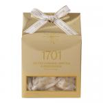 A rectangular box in warm amber and cream tones features a close-up photograph of salted caramel brittle and macadamia-studded honey nougat spilling across the front. Glossy accents catch light, bold elegant text names the flavors, and scattered nuts add texture. Subtle gold foil accents frame view.