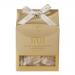 A rectangular box in warm amber and cream tones features a close-up photograph of salted caramel brittle and macadamia-studded honey nougat spilling across the front. Glossy accents catch light, bold elegant text names the flavors, and scattered nuts add texture. Subtle gold foil accents frame view.
