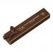 Photograph shows a glossy Belgian chocolate–coated honey nougat bar partly sliced to reveal a soft, ivory, honey-colored interior studded with roasted nuts. The bar sits on a crinkled golden wrapper embossed with a simple confectionery logo against a dark backdrop.