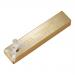 A rectangular nougat bar sits unwrapped, its pale honey-colored interior studded with halved macadamias and amber caramel brittle shards. A glossy caramel drizzle and scattered sea-salt crystals contrast with the soft, chewy nougat texture and toasted nut flecks.
