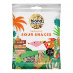 A bright matte pouch sits center, labeled with organic branding and playful typography. A translucent window reveals twisted gummy snakes in vivid red, green, yellow and orange, dusted with sour sugar. The bag edges curl slightly, casting soft shadows on a plain white surface. A subtle matte finish