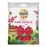 A vibrant pack of Biona Organic Pomegranate Hearts sits against a plain background. The packaging displays ruby-red heart-shaped sweets visible through a clear window, accented by pomegranate illustrations and white typography, giving a natural, colorful, tidy appearance. Soft gloss coats each candy.