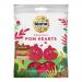 A vibrant pack of Biona Organic Pomegranate Hearts sits against a plain background. The packaging displays ruby-red heart-shaped sweets visible through a clear window, accented by pomegranate illustrations and white typography, giving a natural, colorful, tidy appearance. Soft gloss coats each candy.