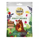 Bright, translucent mini gummy bears in red, orange, yellow, green and purple nestle together in a small clear bag beside a matte cardboard box printed with organic branding; individual bears show glossy surfaces and subtle fruit shapes, creating a colorful, playful arrangement. On a white backdrop.