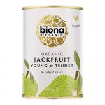 A row of six matte cans sits on a plain surface, each bearing Biona’s green-and-white label with an illustrated jackfruit and crisp typography. The cans display ingredient details and a small organic logo; lighting casts soft highlights and gentle shadows across the arrangement. In soft focus...