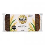 A rustic 500g Biona Organic Rye Bread loaf sits in clear packaging with a Biona Bakery label. Dark, dense crumb shows deep brown color and coarse texture; a thick, crackled crust and scattered rye grains create an artisanal, hearty appearance.