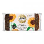 A 500g Biona Organic Rye Bread Sunflower Seed loaf sits in natural brown paper packaging with a clear window, revealing dense dark rye studded with sunflower seeds. Green-and-white Biona Bakery label and basic product text appear on the front.