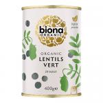 Photo shows six green-lentil packs standing and stacked; each 400g bag displays Biona branding, botanical graphics and clear window revealing small round green lentils. Background is neutral, lighting highlights texture and earthy green tones; packaging labels and text are legible. fine grain texture