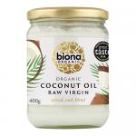 The photo shows six jars of Biona Organic Raw Virgin Coconut Oil with white lids and green-accented labels featuring coconut imagery; translucent glass reveals thick white oil inside, arranged in neat rows on a neutral white background with soft, even lighting. A subtle shadow grounds the composition