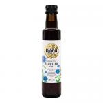 Six 250ml dark glass bottles sit clustered in a shallow cardboard tray, each bearing a clean white label with a delicate flax-flower illustration and green Biona logo. Simple screw caps seal the bottles; light glints off the glass, revealing the warm golden oil within Soft light casts faint shadows