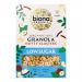 A photograph shows six identical 375g Biona Organic Nutty Clusters Granola packs arranged in two rows. Each pack displays a green Biona logo, white and kraft-colour backdrop, photographic clusters and nut imagery, the product name and a visible 'low sugar' claim on the front. Soft shadows fall across