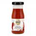 A set of six 130ml Biona Organic Sriracha bottles sits against a plain background. Vivid red sauce shows through clear bottles. Labels are white and green featuring the Biona logo and organic markings; each bottle is topped with a white screw cap.