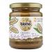 Six 250g glass jars of Biona Organic Whole Sesame Tahini - Salted sit neatly arranged in two rows of three. Each clear jar reveals creamy beige tahini under white lids and features a green-and-white Biona label with product name, photographed against a neutral light backdrop. Soft shadows fall around.
