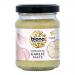 A clear glass jar of Biona Organic Garlic Paste displays pale, creamy paste beneath a green screw lid. The label shows the Biona logo, hand-drawn garlic bulbs and green-and-white typography, presenting a simple, natural visual with clean lines and soft colors.