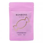 A bright spread shows ten glossy pink packs of strawberry bonbons arranged on white. Each wrapper bears a playful logo and stylized strawberry art. Close-up reveals sugar-dusted, rounded candies peeking from crinkled foil edges, casting soft shadows across the scene. Soft highlights pick out sugars.