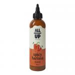 The image shows six 250ml bottles of All Dressed Up Spicy Harissa Dressing. Each clear bottle reveals a vibrant reddish-orange dressing with visible spice flecks. Labels are white with bold red and black text and a minimalist logo. Simple screw-top caps and glossy reflections finish the scene Crisp