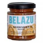 A photo shows six 130g Belazu Shawarma Paste jars neatly arranged in two rows. Clear glass reveals a glossy orange-red paste. Each jar carries a white label with the Belazu logo and product name, topped by a black screw lid that catches soft studio light Subtle shadows fall around the base now