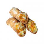 A clear bakery box shows six lemon cannoli arranged in two rows. Each cannolo has a crisp, golden-brown shell dusted with powdered sugar and filled with pale yellow lemon cream, flecked with tiny zest pieces. The box bears the Di Santo & Family Bakery logo.