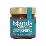 Six 200g jars of Islands Chocolate & Hazelnut Spread sit arranged in two rows on a neutral surface. Each clear jar reveals glossy brown spread, topped by dark lids and branded labels featuring hazelnut and cocoa imagery. Soft studio lighting creates gentle highlights and shadows.