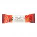 Wrapped bar leans against a stack of identical bars; glossy cream-and-teal wrapper features 'Jade & Joy' logo, caramel drip graphic and blondie image. Unwrapped bar reveals golden blondie with caramel swirls, crumbly texture and a light nutty topping. A minimal white backdrop and soft shadows accent